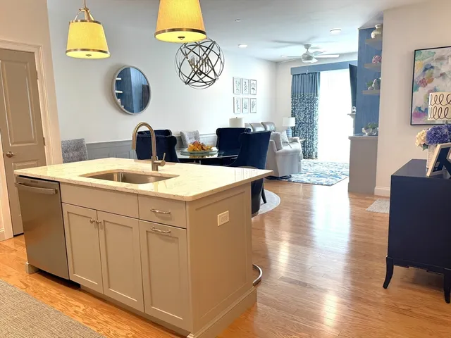 a kitchen with a sink cabinets and wooden floor