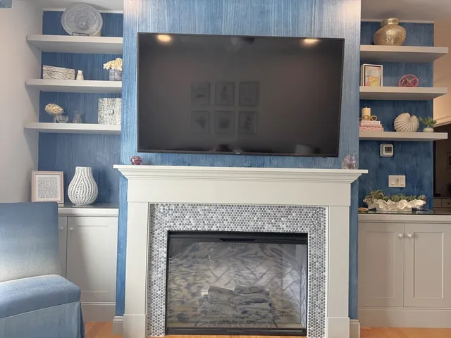 a living room with a fireplace and a table