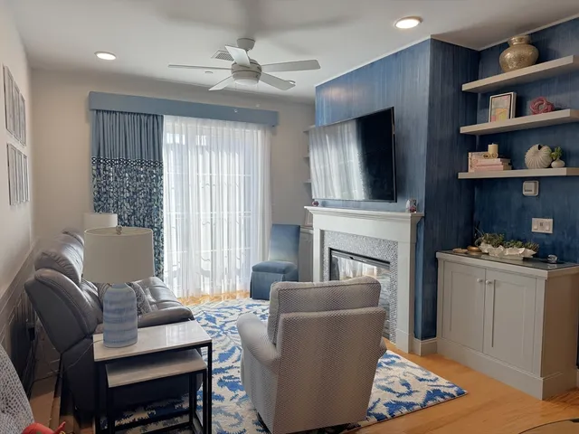 a living room with furniture fireplace and flat screen tv