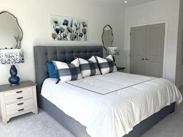 a bedroom with a bed and lamp