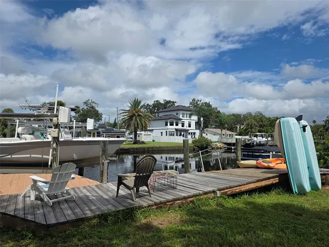 a view of a swimming pool with lawn chairs and a fire pit