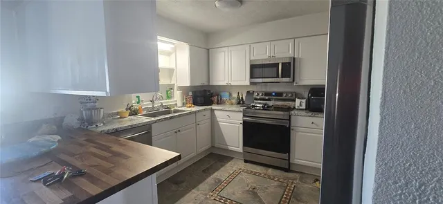 a kitchen with a sink stove and microwave