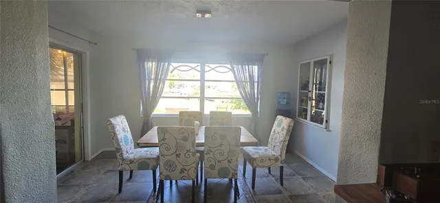 a view of a dining room with furniture and windows