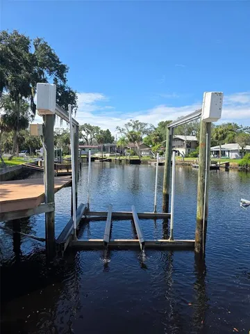 a view of a lake with a floor to ceiling window and wooden floor