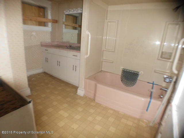139 Spring Street Carbondale, PA 18407 - Photo 22 of 25 a bathroom with a sink a toilet and mirror
