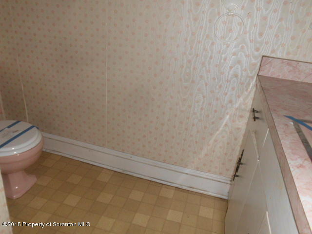 139 Spring Street Carbondale, PA 18407 - Photo 23 of 25 a bathroom with a white toilet and shower