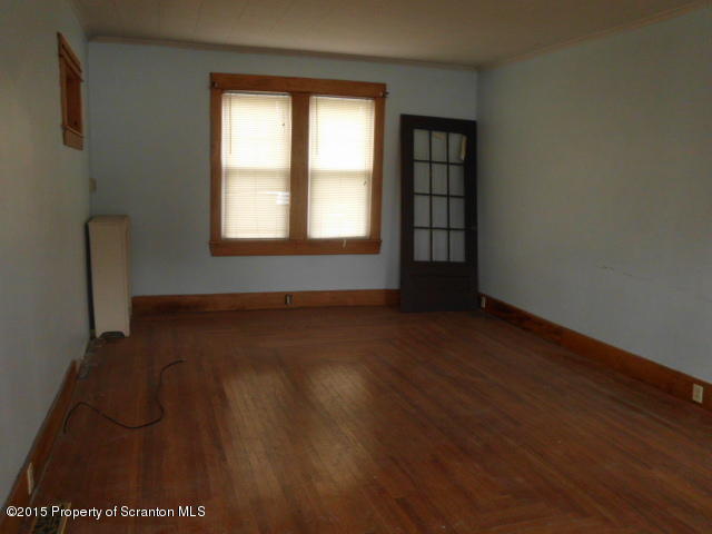 139 Spring Street Carbondale, PA 18407 - Photo 3 of 25 an empty room with wooden floor and windows