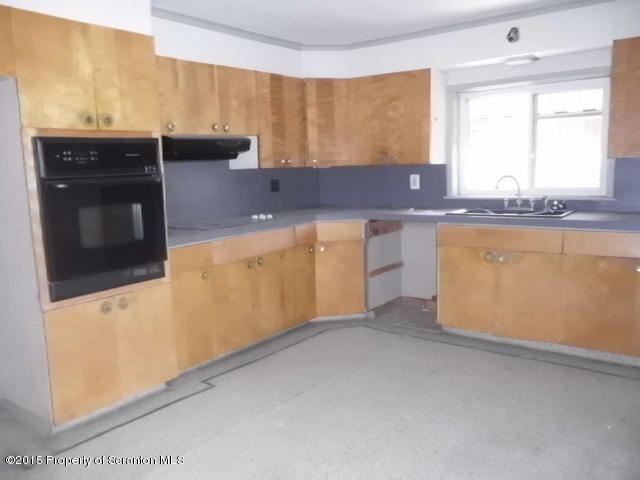 139 Spring Street Carbondale, PA 18407 - Photo 8 of 25 a kitchen with stainless steel appliances granite countertop a sink and a stove