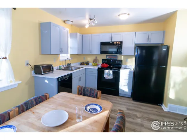a kitchen with kitchen island a refrigerator sink and stove