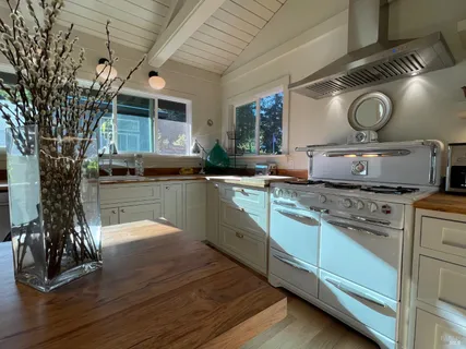 a kitchen with sink stove and cabinets