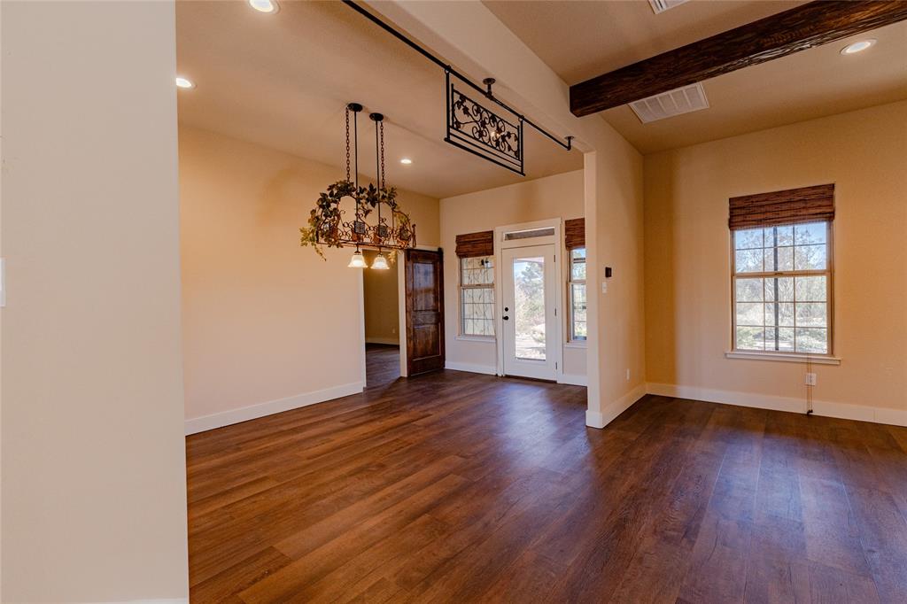1433 County Road 1180 Decatur, TX 76234 - Photo 9 of 36 a view of a room with wooden floor chandelier and a window
