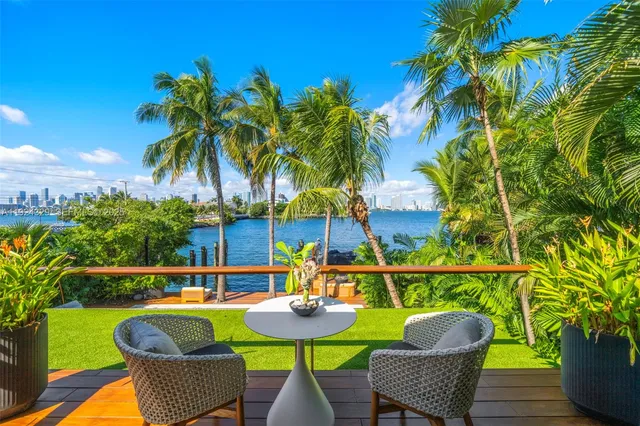 a view of a patio with couches under an umbrella