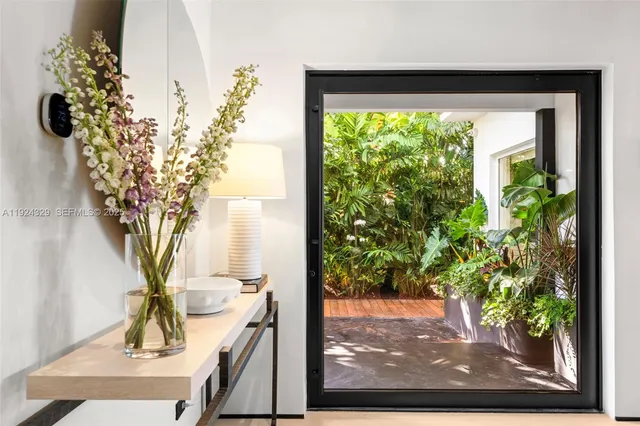 a view of a vase of flowers sitting on a table with window