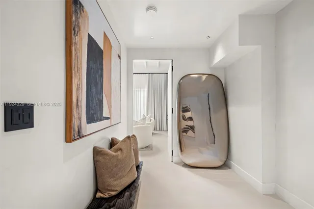 a view of a hallway with couch and dining area