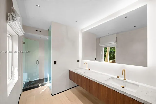 a bathroom with a double vanity sink mirror and double