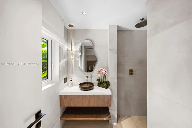 a bathroom with a sink a mirror and window