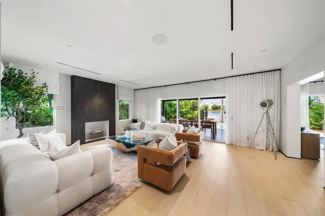 a living room with furniture large window and a flat screen tv