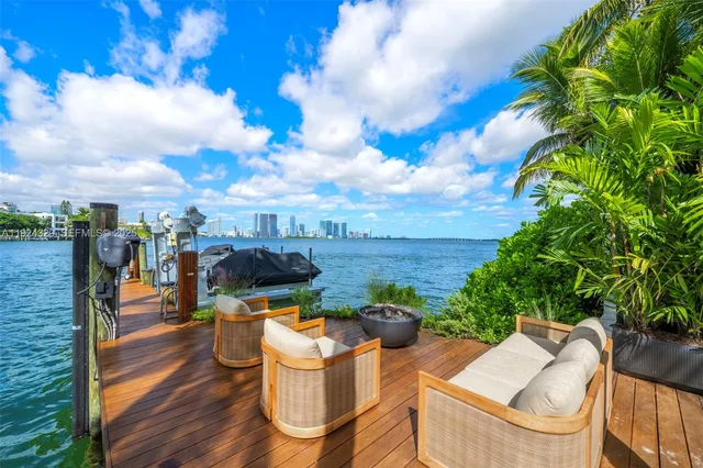 a view of a patio with table and chairs and potted plants