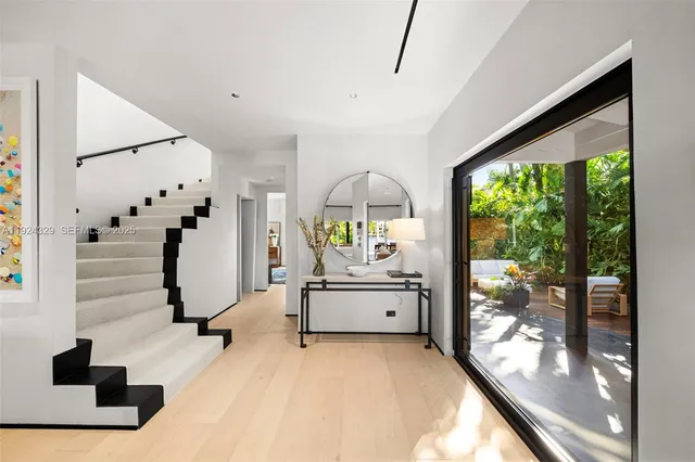 a view of hall way with furniture and staircase