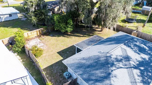 a view of a backyard with swimming pool