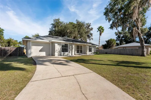 a view of house with outdoor space and swimming pool