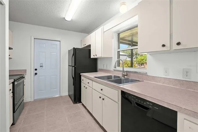 a kitchen with a sink stove and refrigerator
