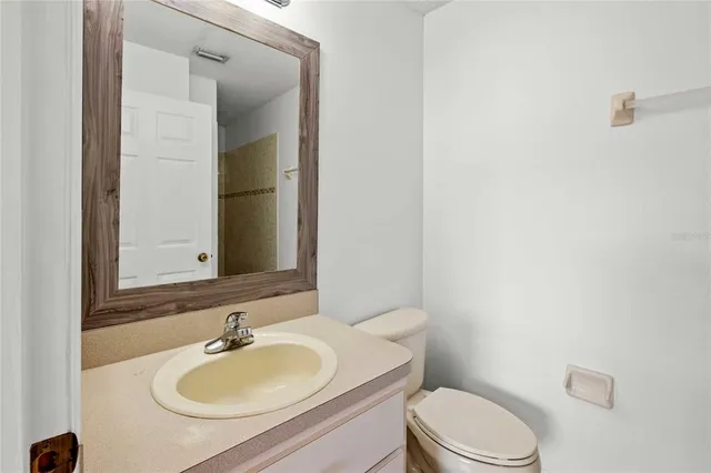 a bathroom with a sink a toilet and mirror