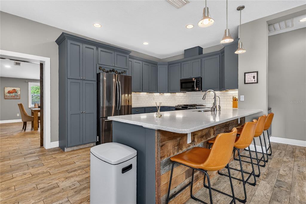 1795 Brumley Road Chuluota, FL 32766 - Photo 11 of 41 a kitchen with stainless steel appliances a refrigerator and a stove top oven