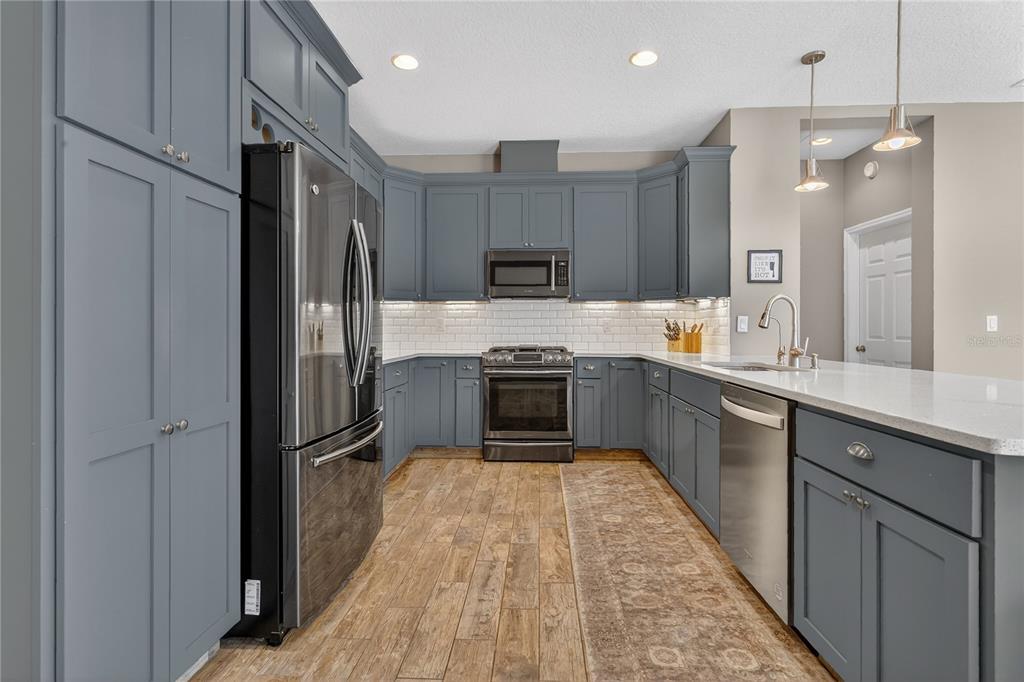 1795 Brumley Road Chuluota, FL 32766 - Photo 12 of 41 a kitchen with kitchen island a counter top space a sink appliances and cabinets