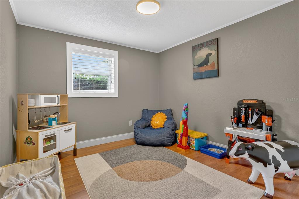 1795 Brumley Road Chuluota, FL 32766 - Photo 13 of 41 a bedroom with furniture and a book shelf