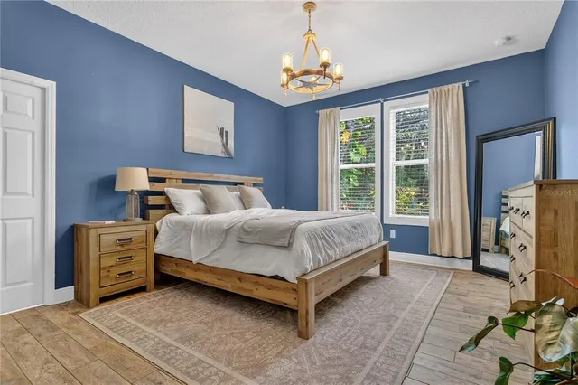a bedroom with a bed closet and flat tv screen