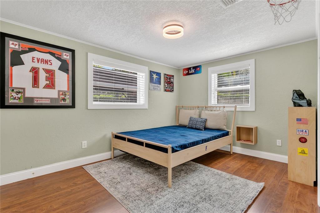 1795 Brumley Road Chuluota, FL 32766 - Photo 19 of 41 a bedroom with a bed and wooden floor