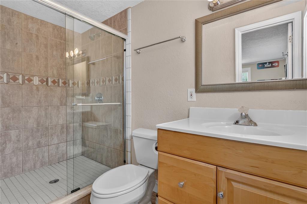 1795 Brumley Road Chuluota, FL 32766 - Photo 21 of 41 a bathroom with a sink toilet vanity and shower