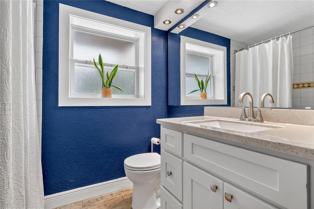 1795 Brumley Road Chuluota, FL 32766 - Photo 22 of 41 a bathroom with a toilet a sink and mirror