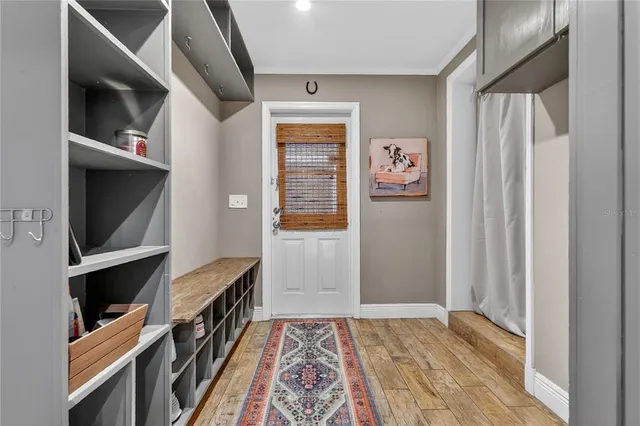 a hallway with cabinets and wooden floor
