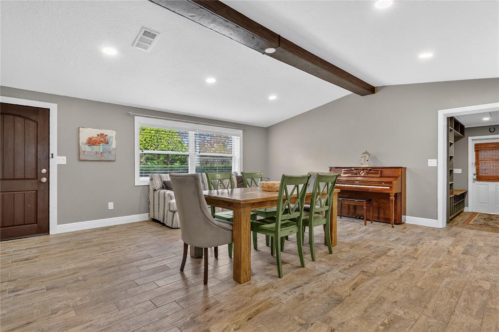 1795 Brumley Road Chuluota, FL 32766 - Photo 3 of 41 a view of a dining room with furniture window and wooden floor