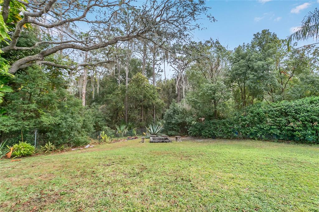 1795 Brumley Road Chuluota, FL 32766 - Photo 32 of 41 a view of outdoor space with deck and yard