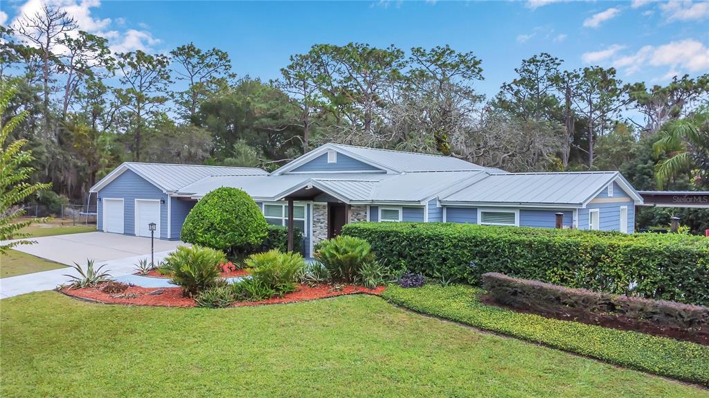 1795 Brumley Road Chuluota, FL 32766 - Photo 36 of 41 a front view of a house with a yard and garage