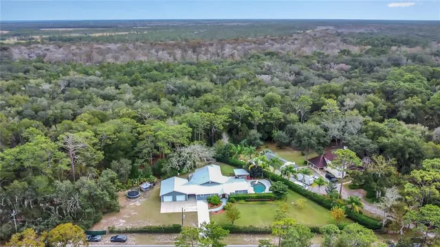 an aerial view of a house with a yard