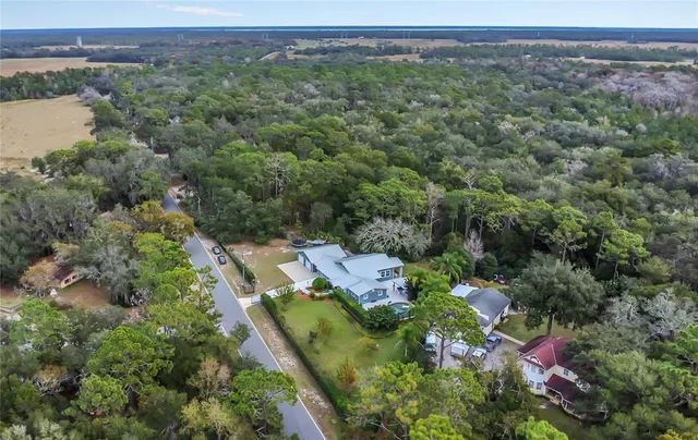 an aerial view of a house with a yard