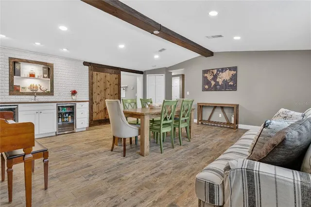 a living room with furniture a wooden floor and a painting