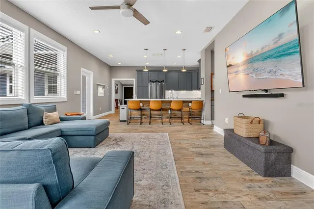 a living room with furniture and wooden floor