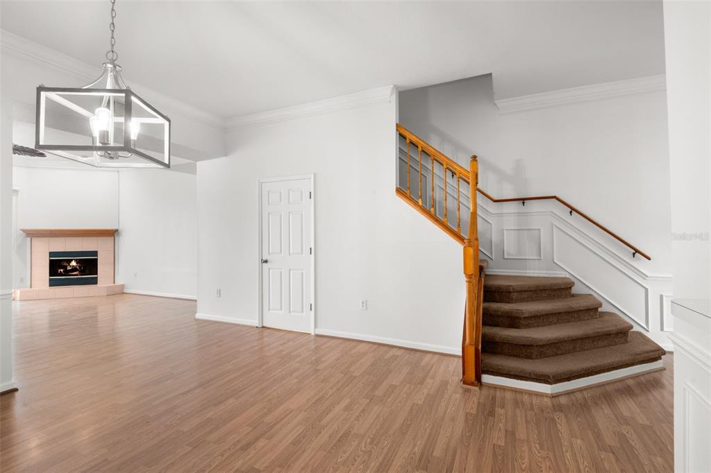 1644 Arabian Lane Palm Harbor, FL 34685 - Photo 12 of 52 a view of an empty room with wooden floor and stairs