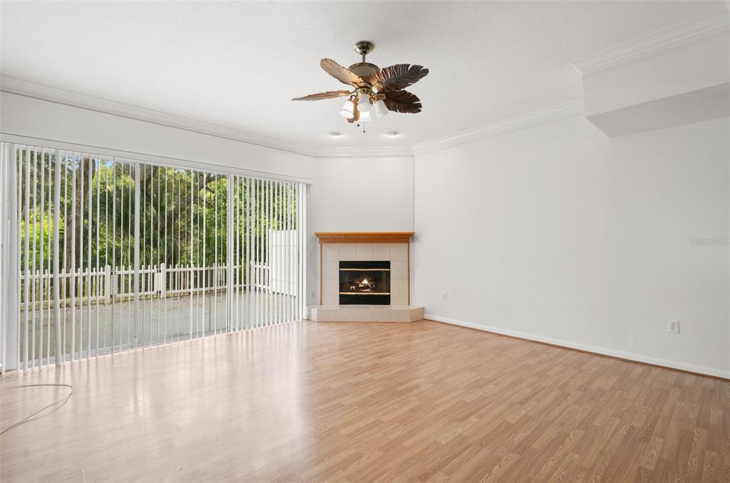 1644 Arabian Lane Palm Harbor, FL 34685 - Photo 16 of 52 a view of an empty room with wooden floor and a fireplace