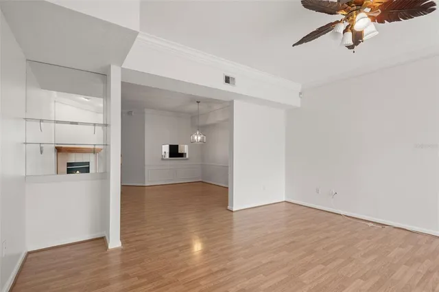 a view of a big room with wooden floor and windows