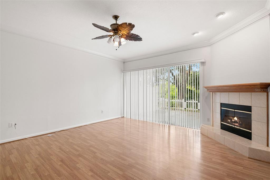 1644 Arabian Lane Palm Harbor, FL 34685 - Photo 19 of 52 a view of an empty room with a fireplace and a window
