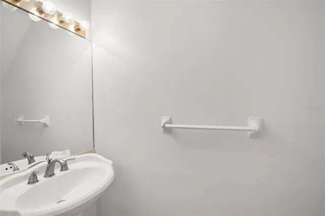 a bathroom with a sink and mirror