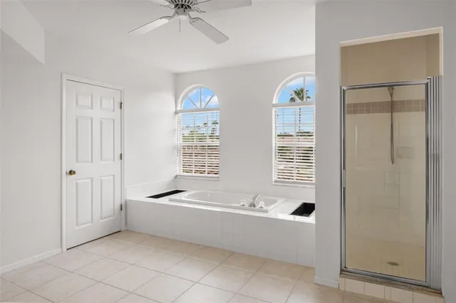 a spacious bathroom with a bathtub and a shower