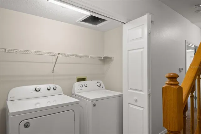 a view of storage and utility room with washer and dryer