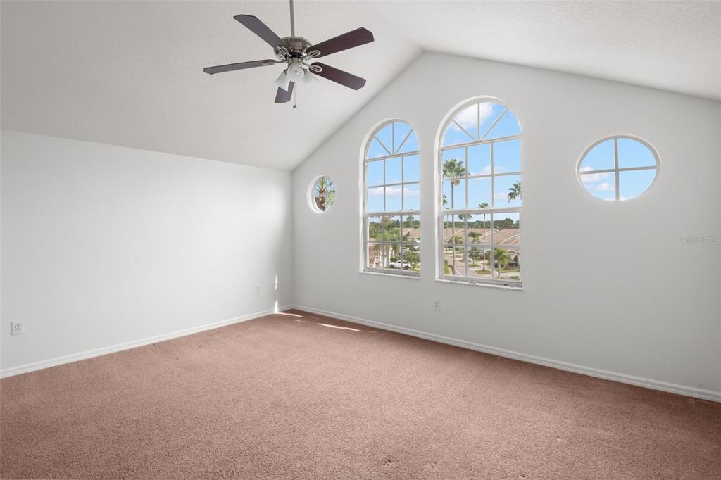 1644 Arabian Lane Palm Harbor, FL 34685 - Photo 38 of 52 an empty room with windows and ceiling fan